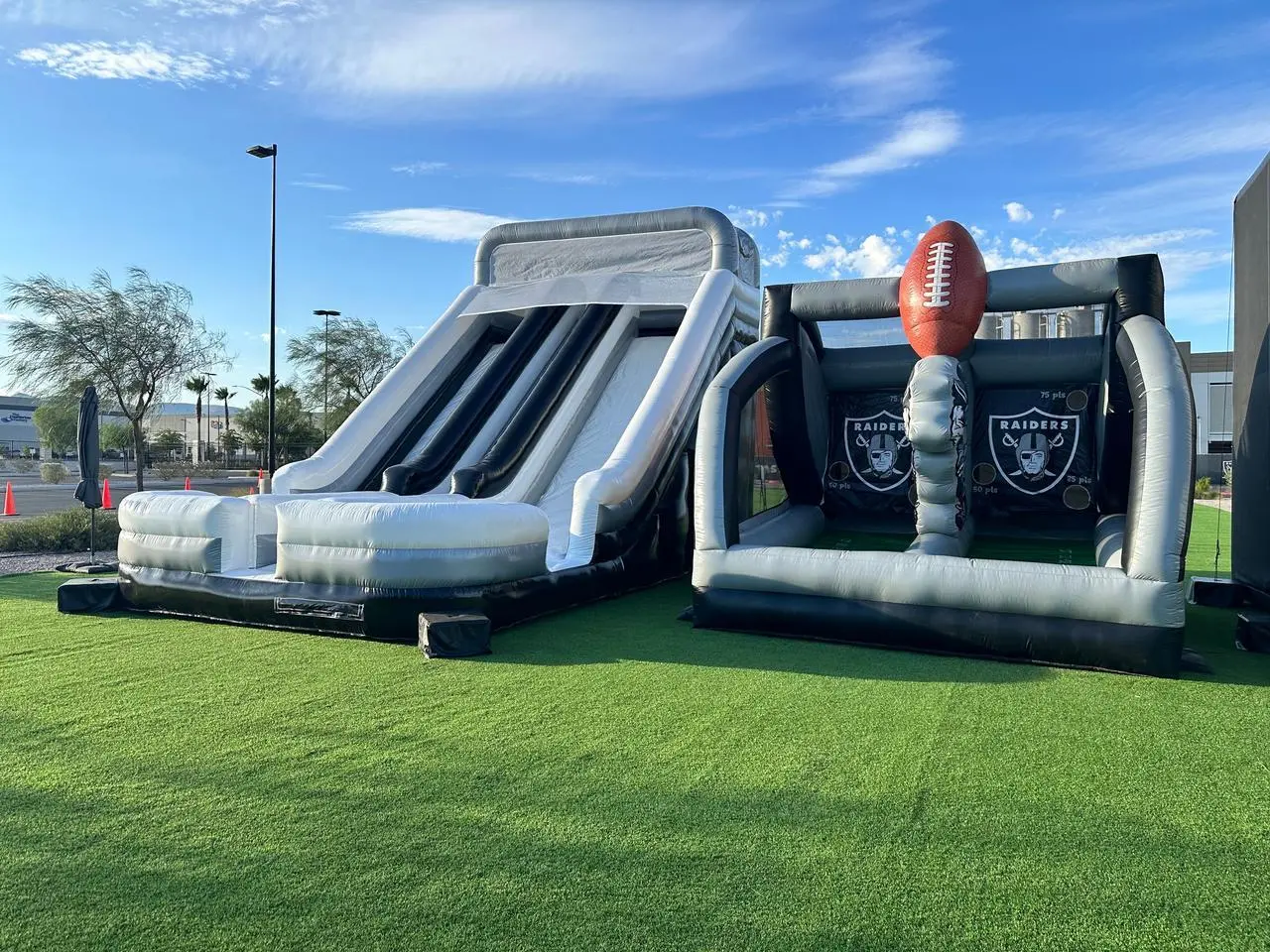Raiders Football Themed Inflatable Slide Goal Kick Game Artificial Turf Event Production Las Vegas