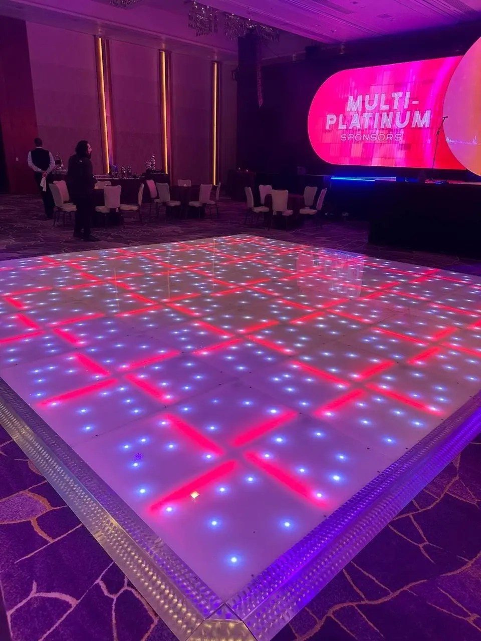 Indoor event with LED dance floor and multi-platinum sponsors screen in Las Vegas