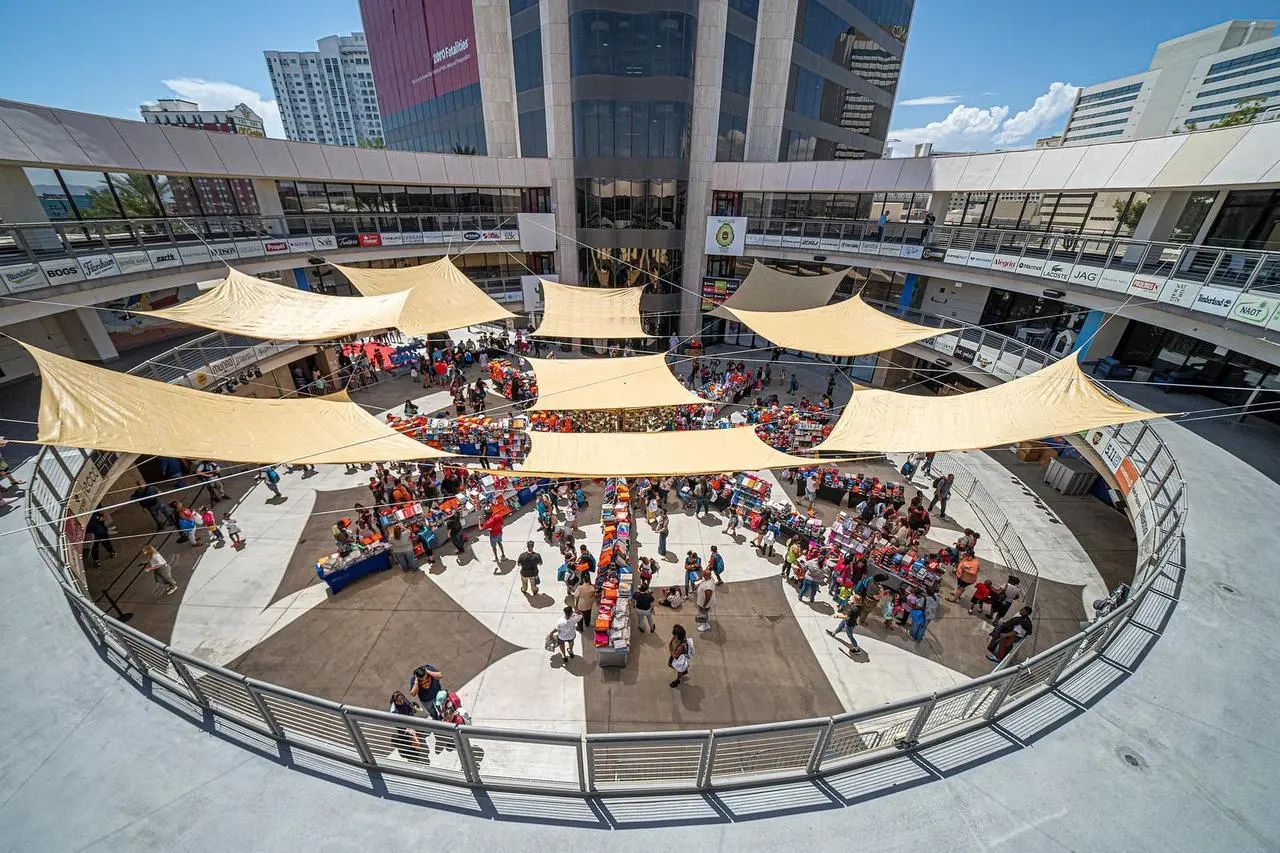 Aerial view of outdoor market festival with vendor stalls and shade sails in plaza in Las Vegas